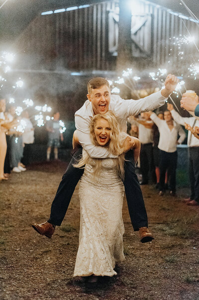 bride giving husband piggy back ride