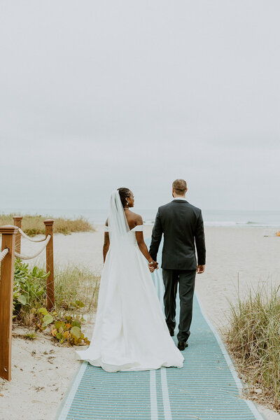 Newlyweds dance under a clear tent to a live band at their reception