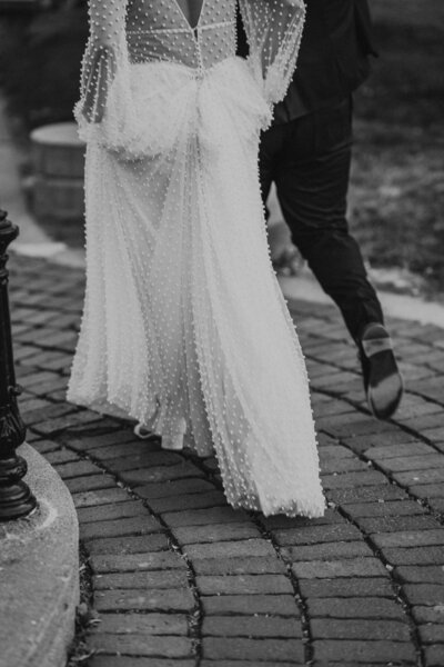 Bride and groom feet as they walk into the distance.