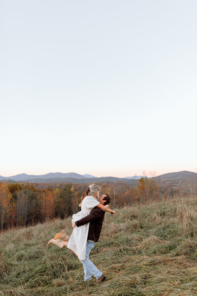 Couple kissing as the husband picks up his wife.
