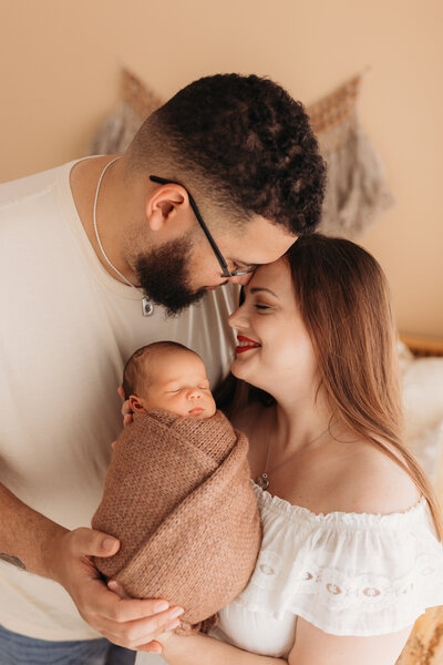 MAternity photo session with parents holding newborn baby
