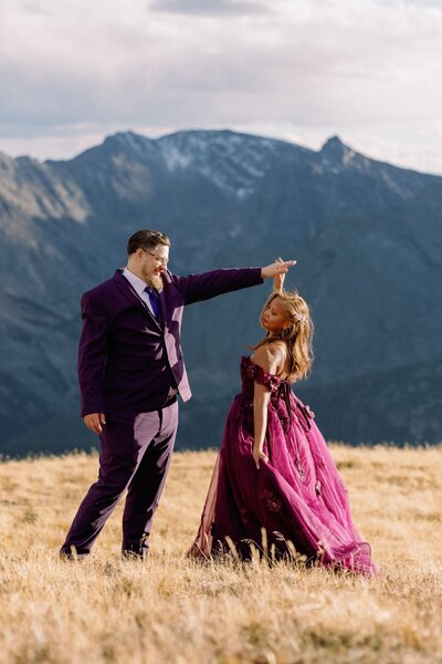 Bride and groom dance on Estes Park mountain top during intimate wedding.