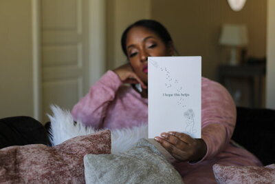woman holding out book
