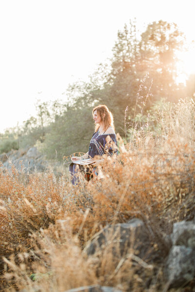 woman meditating on a rock outside