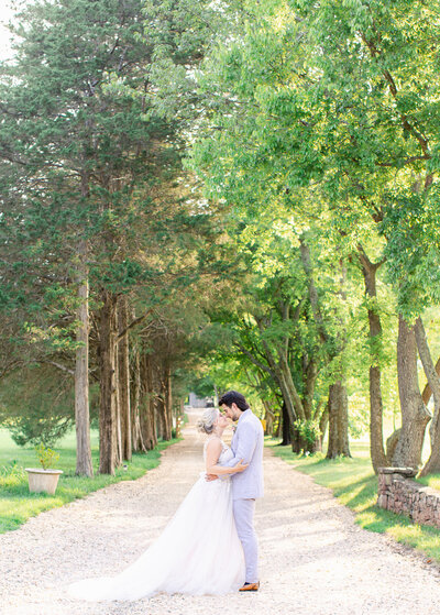 Bride and Groom during wedding portraits in tree covered drive way at Great Marsh Estate in Bealeton, Virginia. Taken by Bethany Aubre Photography.