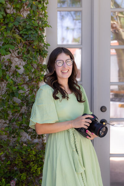 Photographer laughing with her camera