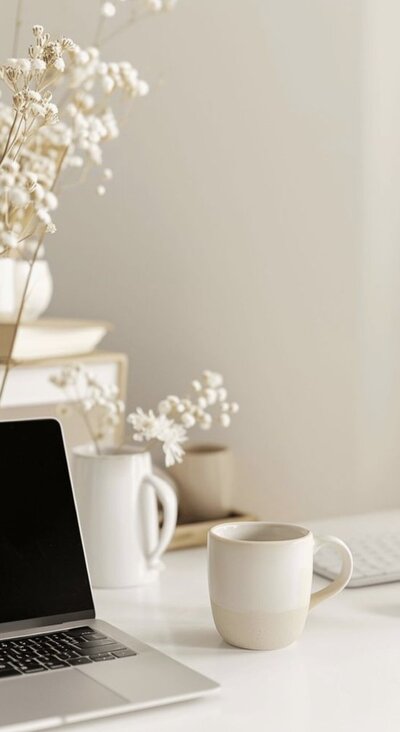 Aesthetic workspace with laptop and coffee mug – behind-the-scenes look at Karla Jane Web Design studio style.