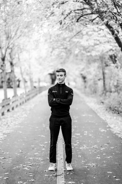 Senior boy poses on the Monon Trail during his portrait session near Carmel Arts & Design District in Indiana