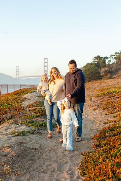 Family photos in front of the golden gate bridge in san francisco. 