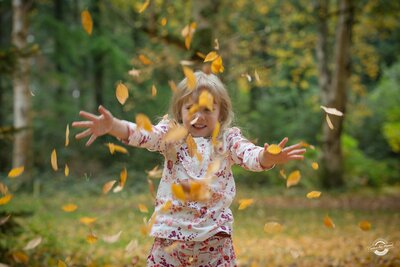 Girl throwing leaves Autumn family photography| Gloucestershire Family Photographer