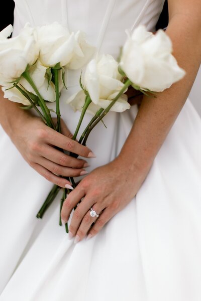 bride elegantly holding her bouquet of flowers