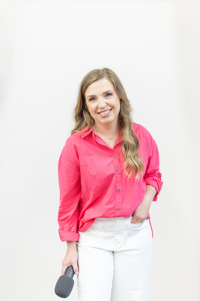 Erika smiling in a pink button down shirt