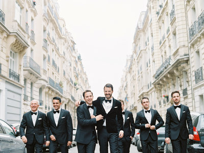 Groomsmen walking down Paris streets