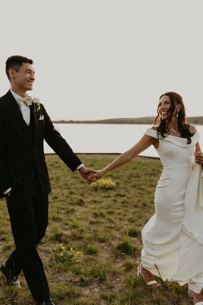 couple holding hands and kissing in front of building
