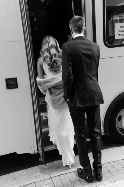 bride and groom stepping on to their wedding bus in philadelphia