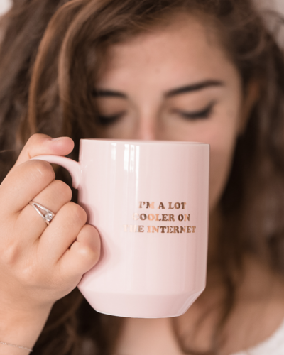 woman holding a mug with a quote