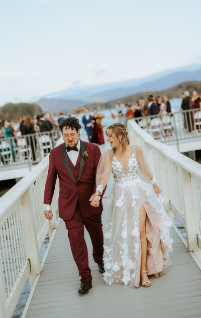 Bride and groom by the water, smiling