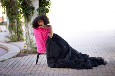 African girl in pink chair portrait