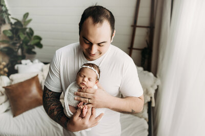 Dad holding his brand new baby girl