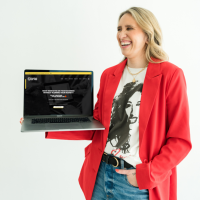 Creative expert in website design and SEO packages for small business impact, holding a laptop with portfolio samples