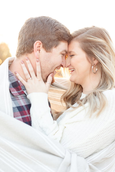 couple celebrates engagement druingsunset