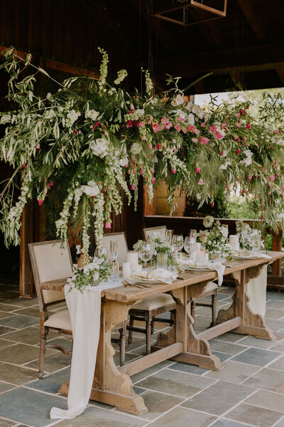 A large suspended floral design over a reception table for a Nashville wedding