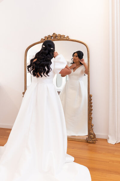 bride at The Valley Estate bridal prep with glam makeup, hair half updo