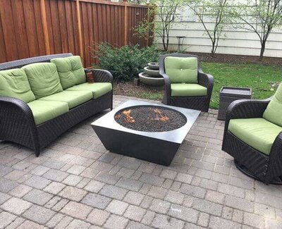 Modern concrete fire pit with round fire source and square base