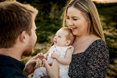 mom and dad with a new baby at a photo session in southlake texas