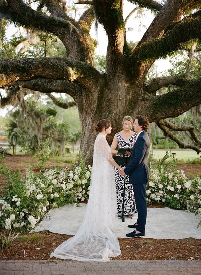Bride and groom ceremony outside in front of tree