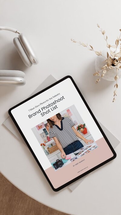 Tablet, a vase, and a pair of Apple headphones on a table with Abby Murphy's free download: Brand Photoshoot Shot List: 7 Must-Have Photos for Any Industry
