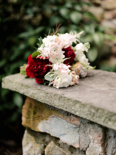 November wedding at Graylyn Estate, designed and planned by Charming Carolina — close-up of the bride’s bouquet featuring seasonal blooms and textured fall foliage.