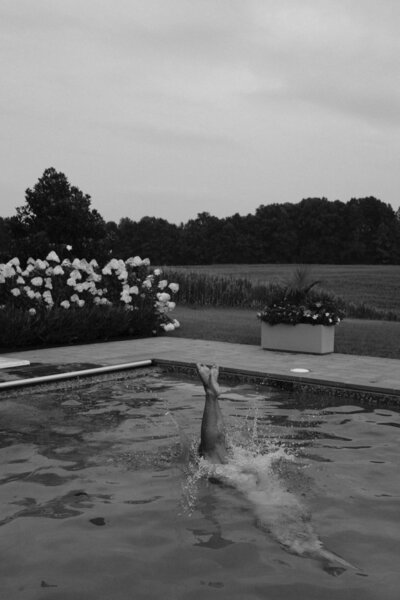 black and white photo of man underwater