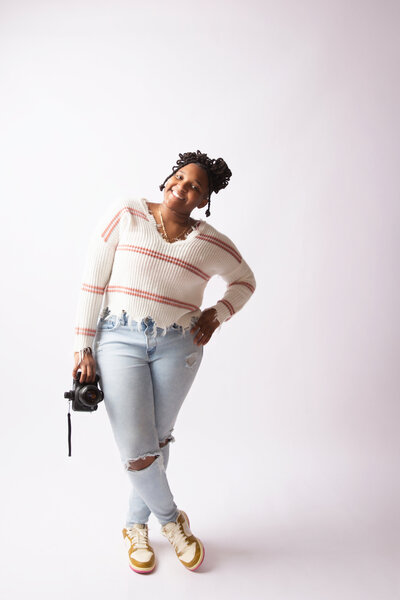 Kristal smiling with disco ball in hand at Hacker Medias Chattanooga Photography Studio.