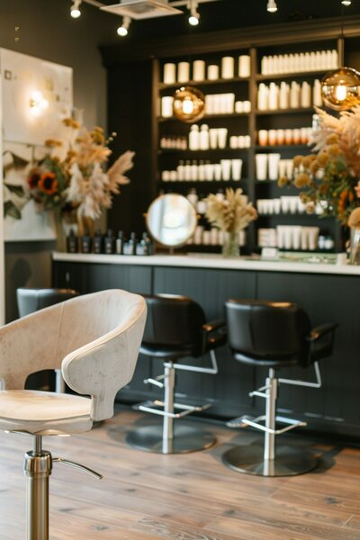 Sleek and inviting interior, featuring modern styling chairs, well-stocked product shelves, and a sophisticated ambiance.