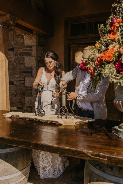 The bride and groom brand a piece of wood during their ceremony, forging a lasting symbol of unity, tradition, and the start of their shared legacy.