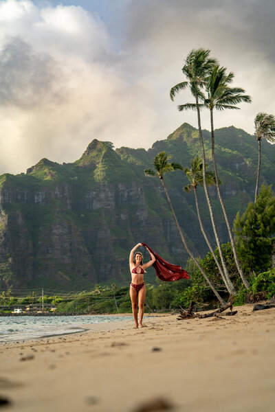 Solo portrait of a woman walking on beach taken by Big Island Hawaii Photographer