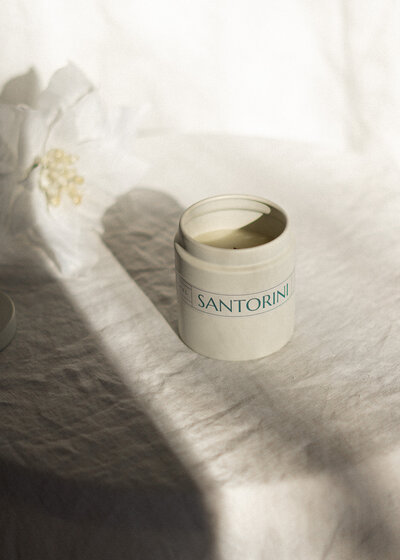 Santorini travel themed candle with wood wick and natural soy in a reusable container