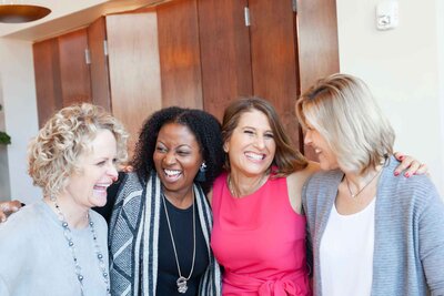 group of women being photographed at a corporate event
