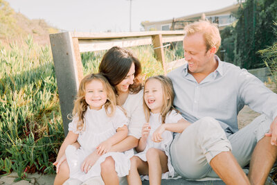 family laughing on the beach with Halleigh Hill