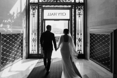 newlyweds walking out of city hall