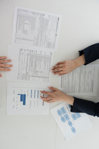 Tax advisor for entrepreneurs at Romo CPA Tax + Advisory in Dallas, TX, showcasing client documents and strategic planning materials in a professional office setting.