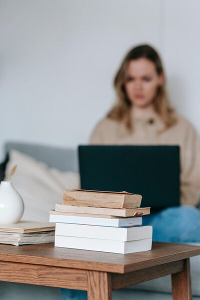 Woman on computer with books
