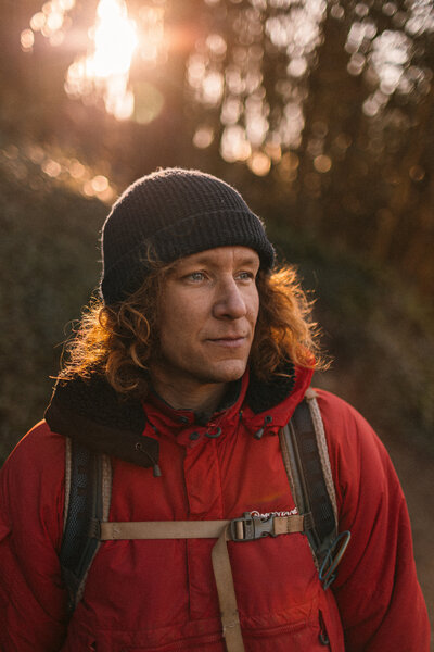 Portrait of a man wearing outdoor clothing in winter at sunrise 
