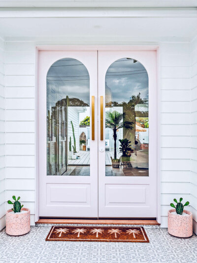 pink front door of coastal home