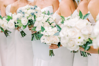 Bridal party holding white flower bouquets