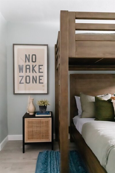 Kids bedroom with black and wood nightstand