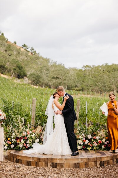 bride and groom have first kiss at medlock ames winery wedding in healdsburg, ca