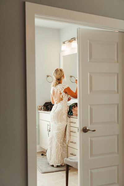 Bride getting ready at beach house before going to her intimate ceremony on Navarre beach 