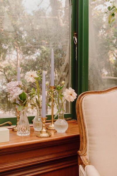 Flowers and candles in front of a window